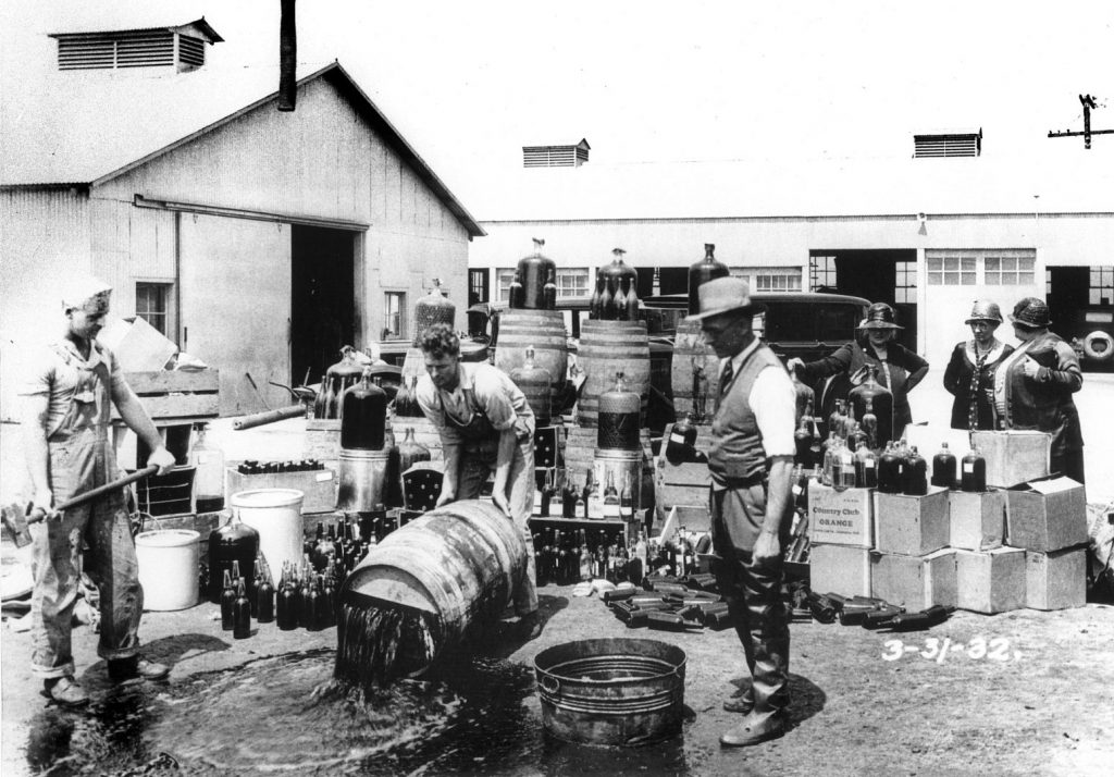 Orange County Sheriffs' deputies dumping illegal booze, Santa Ana 3/31/1932