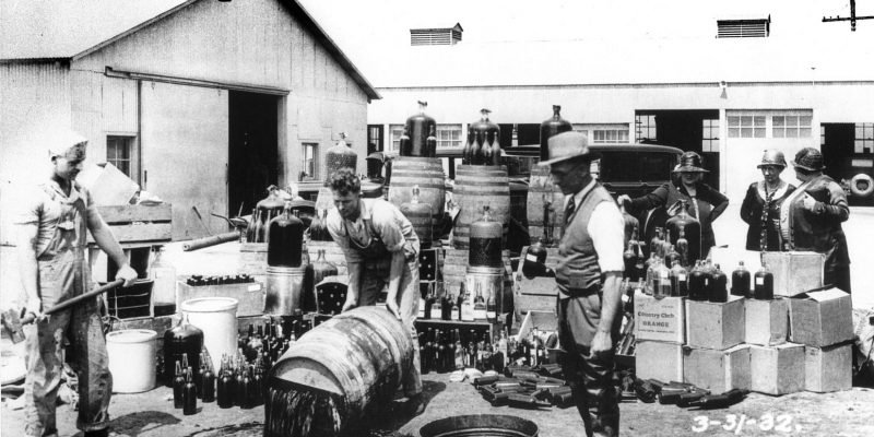 Orange County Sheriffs' deputies dumping illegal booze, Santa Ana 3/31/1932